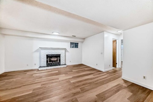 314 Castleridge Drive Ne, Calgary, AB - Indoor Photo Showing Living Room With Fireplace