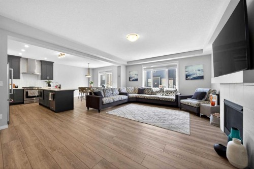 95 Carrington Close Nw, Calgary, AB - Indoor Photo Showing Other Room With Fireplace