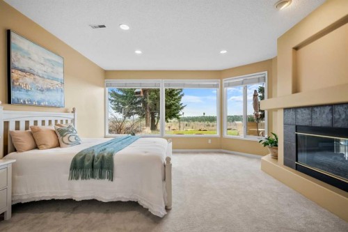 12820 Canso Crescent Sw, Calgary, AB - Indoor Photo Showing Bedroom With Fireplace