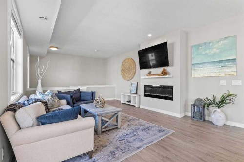 306 Cranbrook Walk Se, Calgary, AB - Indoor Photo Showing Living Room With Fireplace