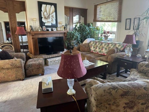 1435 22 Avenue, Didsbury, AB - Indoor Photo Showing Living Room With Fireplace