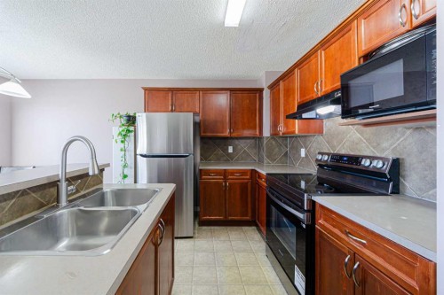 133 Saddlefield Place Ne, Calgary, AB - Indoor Photo Showing Kitchen With Double Sink