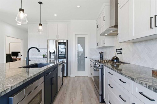 303 Rivercrest Boulevard, Cochrane, AB - Indoor Photo Showing Kitchen With Upgraded Kitchen