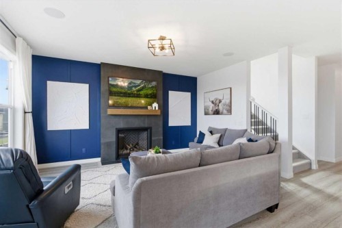 303 Rivercrest Boulevard, Cochrane, AB - Indoor Photo Showing Living Room With Fireplace