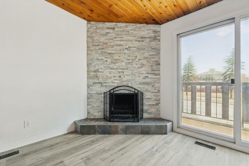 B-1415 44 Street Se, Calgary, AB - Indoor Photo Showing Living Room With Fireplace