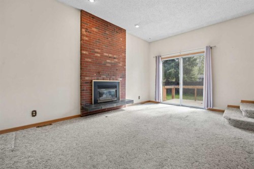 5220 Grove Hill Road Sw, Calgary, AB - Indoor Photo Showing Living Room With Fireplace
