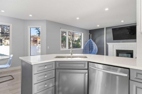 48 Douglas Park Boulevard Se, Calgary, AB - Indoor Photo Showing Kitchen With Fireplace