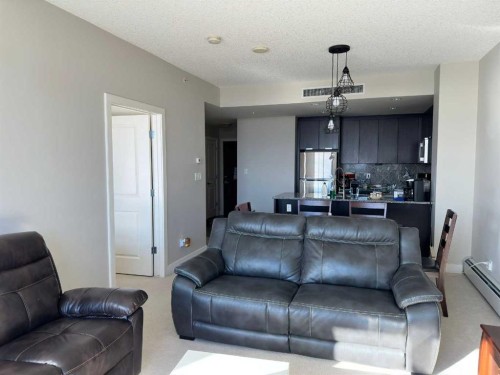 1104-99 Spruce Place Sw, Calgary, AB - Indoor Photo Showing Living Room