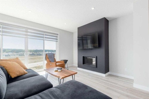 99 Haskayne Drive Nw, Calgary, AB - Indoor Photo Showing Living Room With Fireplace