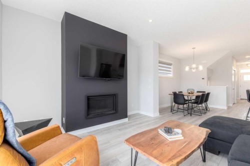 99 Haskayne Drive Nw, Calgary, AB - Indoor Photo Showing Living Room With Fireplace