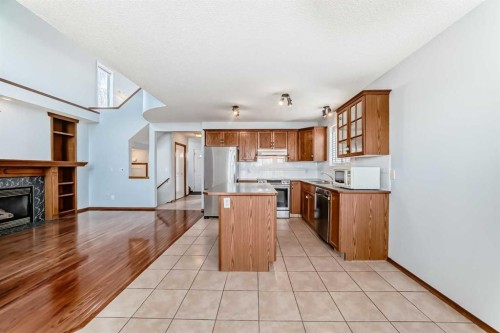 42 Harvest Rose Place Ne, Calgary, AB - Indoor Photo Showing Kitchen With Fireplace