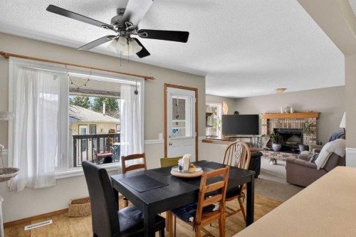 44 Riverwood Circle Se, Calgary, AB - Indoor Photo Showing Dining Room With Fireplace