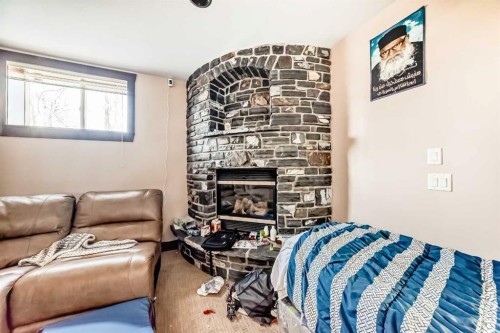 602 Wentworth Place Sw, Calgary, AB - Indoor Photo Showing Bedroom With Fireplace