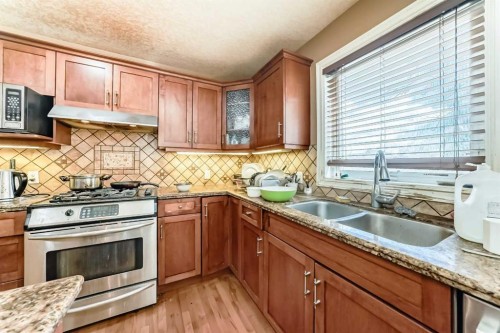 602 Wentworth Place Sw, Calgary, AB - Indoor Photo Showing Kitchen With Stainless Steel Kitchen With Double Sink