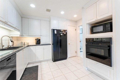 8 Prominence Path Sw, Calgary, AB - Indoor Photo Showing Kitchen With Double Sink