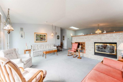 8 Prominence Path Sw, Calgary, AB - Indoor Photo Showing Living Room With Fireplace