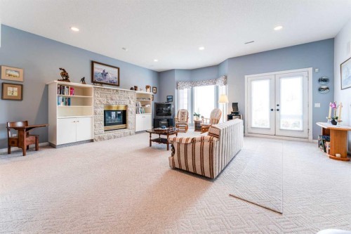 8 Prominence Path Sw, Calgary, AB - Indoor Photo Showing Living Room With Fireplace