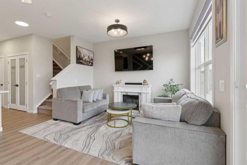 79 Magnolia Heath Se, Calgary, AB - Indoor Photo Showing Living Room With Fireplace