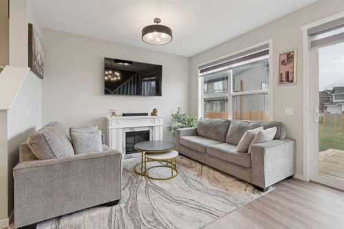 79 Magnolia Heath Se, Calgary, AB - Indoor Photo Showing Living Room With Fireplace