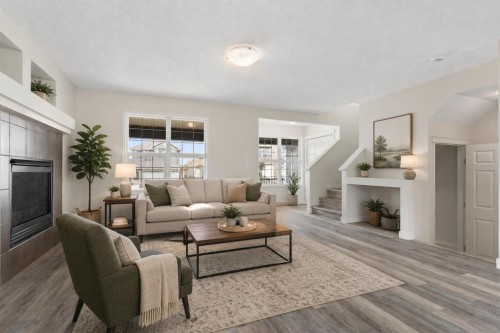 202 Sunset Heights, Cochrane, AB - Indoor Photo Showing Living Room With Fireplace