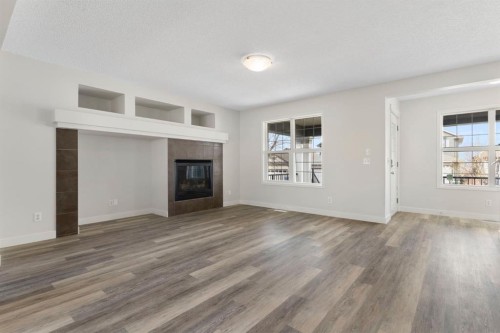 202 Sunset Heights, Cochrane, AB - Indoor Photo Showing Living Room With Fireplace