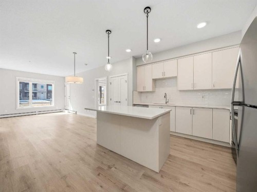 110-660 Shawnee Square Sw, Calgary, AB - Indoor Photo Showing Kitchen With Upgraded Kitchen