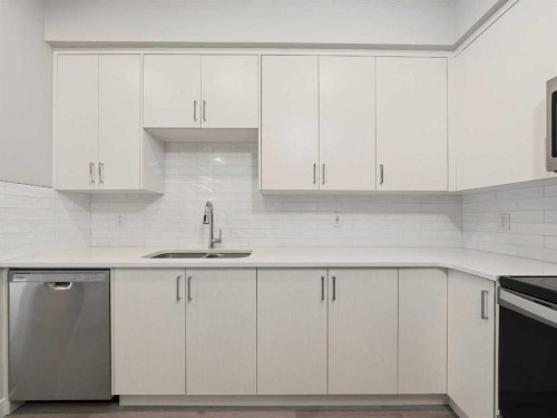 110-660 Shawnee Square Sw, Calgary, AB - Indoor Photo Showing Kitchen With Double Sink