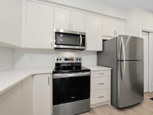 110-660 Shawnee Square Sw, Calgary, AB - Indoor Photo Showing Kitchen With Stainless Steel Kitchen