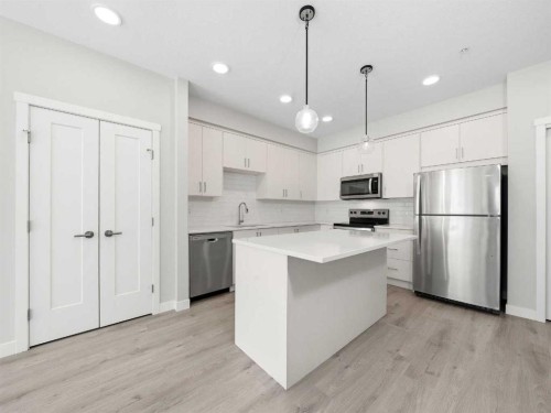 110-660 Shawnee Square Sw, Calgary, AB - Indoor Photo Showing Kitchen With Stainless Steel Kitchen With Upgraded Kitchen