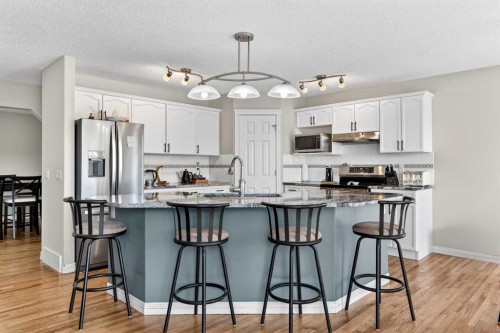 99 Evansmeade Crescent Nw, Calgary, AB - Indoor Photo Showing Kitchen With Stainless Steel Kitchen With Double Sink With Upgraded Kitchen