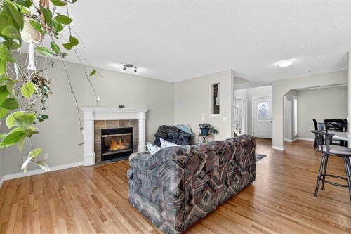 99 Evansmeade Crescent Nw, Calgary, AB - Indoor Photo Showing Living Room With Fireplace