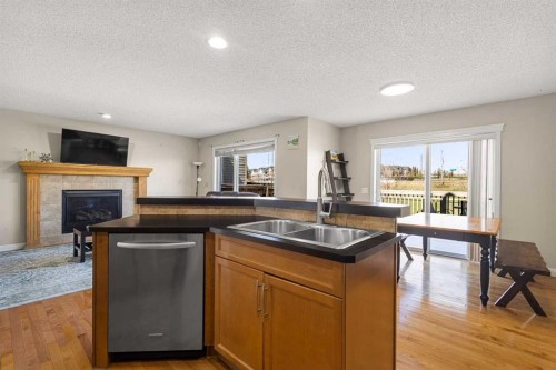 92 Covehaven Terrace Ne, Calgary, AB - Indoor Photo Showing Kitchen With Fireplace With Double Sink
