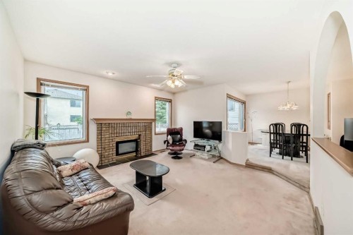 83 Hawkmount Green Nw, Calgary, AB - Indoor Photo Showing Living Room With Fireplace