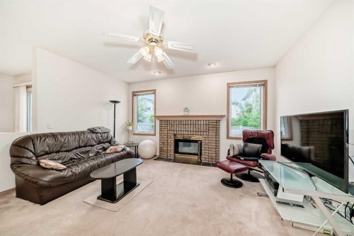83 Hawkmount Green Nw, Calgary, AB - Indoor Photo Showing Living Room With Fireplace