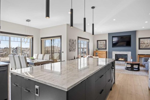 3 Tremblant Point Sw, Calgary, AB - Indoor Photo Showing Kitchen With Fireplace