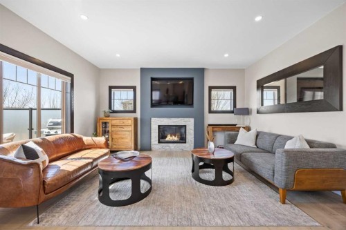 3 Tremblant Point Sw, Calgary, AB - Indoor Photo Showing Living Room With Fireplace