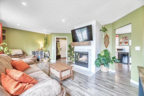 112 Thorson Crescent, Okotoks, AB - Indoor Photo Showing Living Room With Fireplace