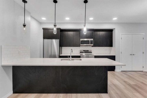 3201-220 Seton Grove Se, Calgary, AB - Indoor Photo Showing Kitchen With Stainless Steel Kitchen With Double Sink With Upgraded Kitchen