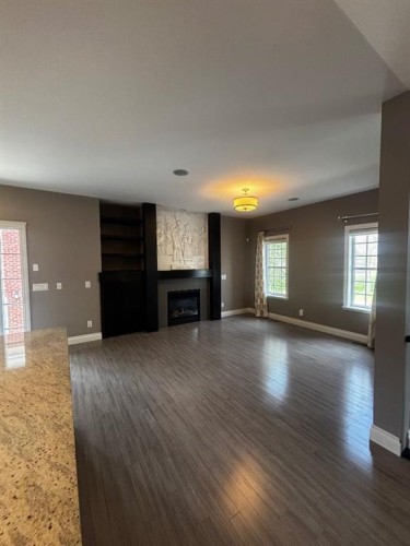1 Murmansk Way Sw, Calgary, AB - Indoor Photo Showing Living Room With Fireplace