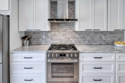 79 Riverview Circle, Cochrane, AB - Indoor Photo Showing Kitchen With Upgraded Kitchen