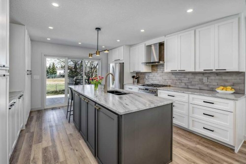 79 Riverview Circle, Cochrane, AB - Indoor Photo Showing Kitchen With Double Sink With Upgraded Kitchen