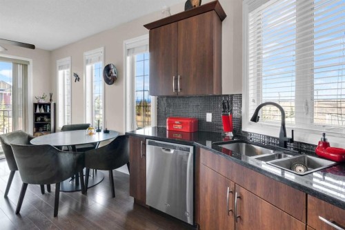 2101-15 Sunset Square, Cochrane, AB - Indoor Photo Showing Kitchen With Double Sink