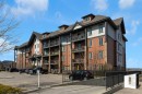 2101-15 Sunset Square, Cochrane, AB  - Outdoor With Balcony With Facade 