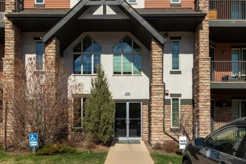 2101-15 Sunset Square, Cochrane, AB - Outdoor With Balcony With Facade