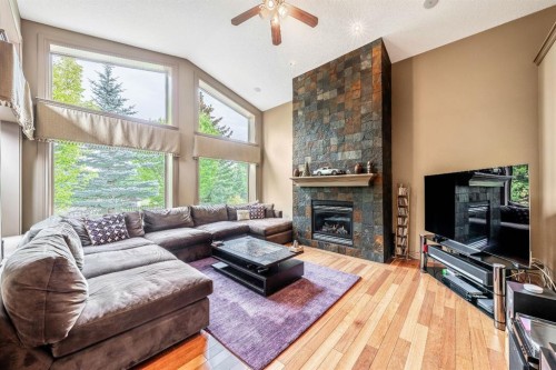 212 Aspen Meadows Place Sw, Calgary, AB - Indoor Photo Showing Living Room With Fireplace