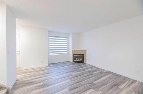 36-111 Tarawood Lane Ne, Calgary, AB - Indoor Photo Showing Other Room With Fireplace