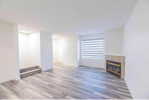 36-111 Tarawood Lane Ne, Calgary, AB - Indoor Photo Showing Living Room With Fireplace