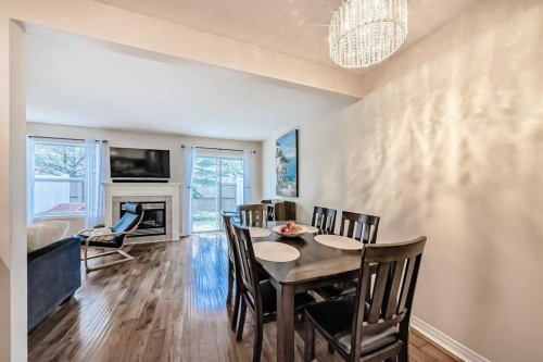 103 Everstone Place Sw, Calgary, AB - Indoor Photo Showing Dining Room With Fireplace