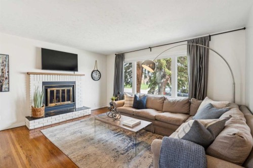 19 Hyslop Drive Sw, Calgary, AB - Indoor Photo Showing Living Room With Fireplace