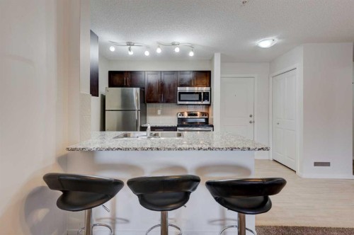 2125-81 Legacy Boulevard Se, Calgary, AB - Indoor Photo Showing Kitchen With Stainless Steel Kitchen With Double Sink With Upgraded Kitchen